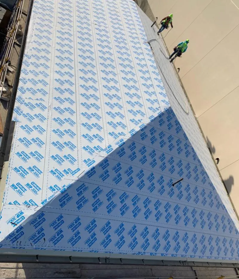 Professional roofers installing underlayment on a metal roof in Canyon